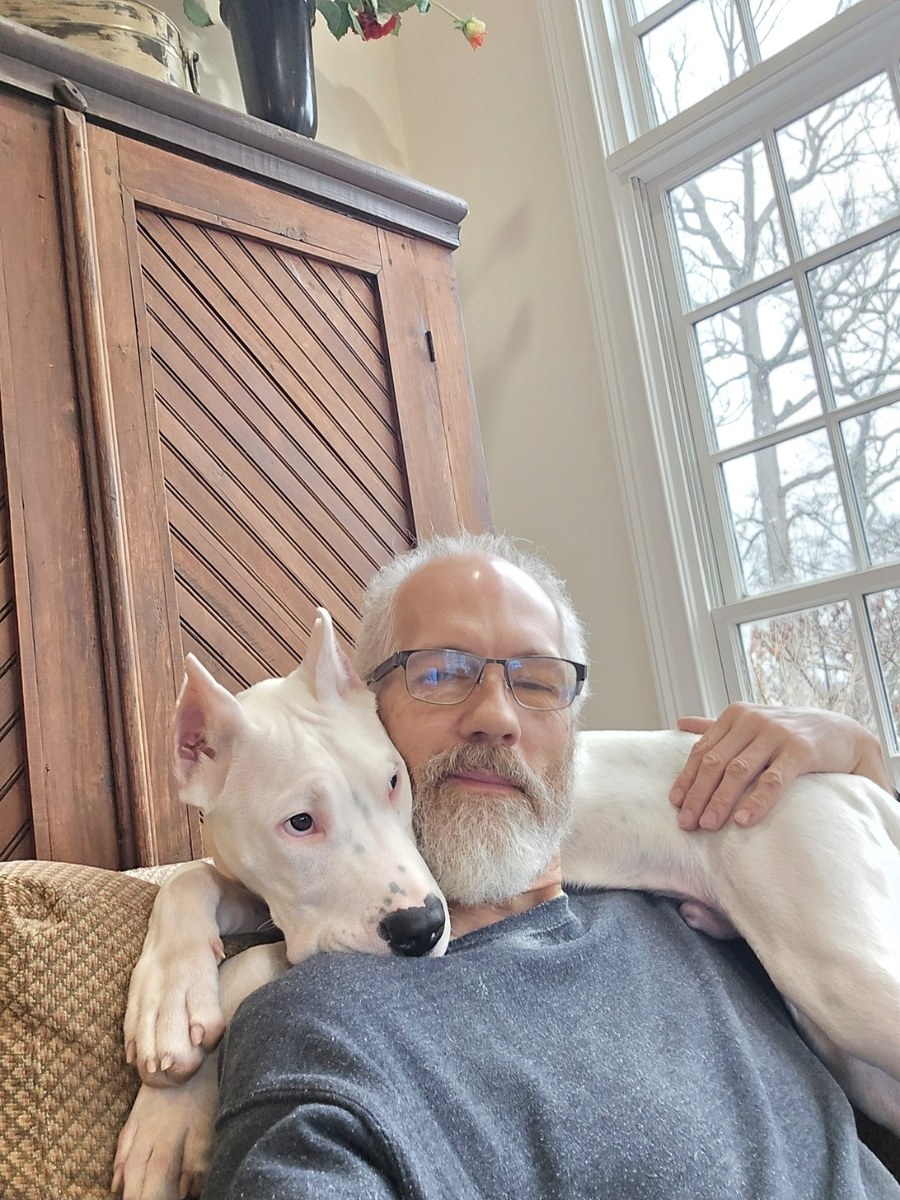 Charles Hill II at home with his dog