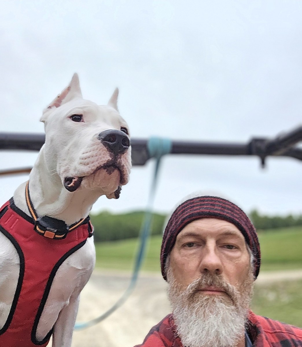 Charles Hill II outdoors with his dog
